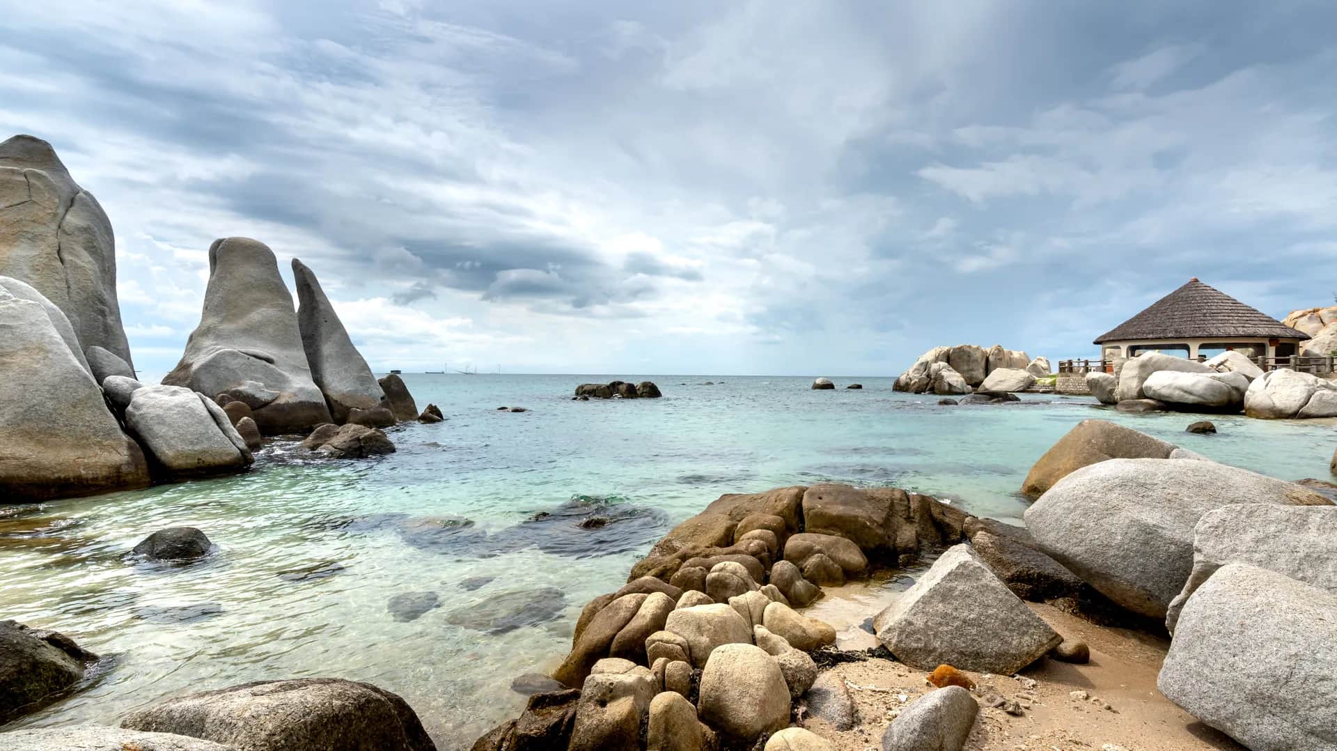 Romantic beachfront wedding venue setup on white sand beach in Belitung with turquoise ocean backdrop
