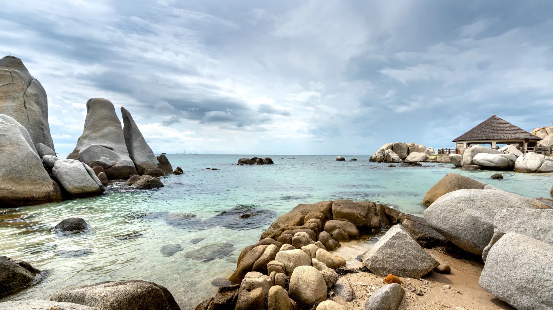 Romantic beachfront wedding venue setup on white sand beach in Belitung with turquoise ocean backdrop